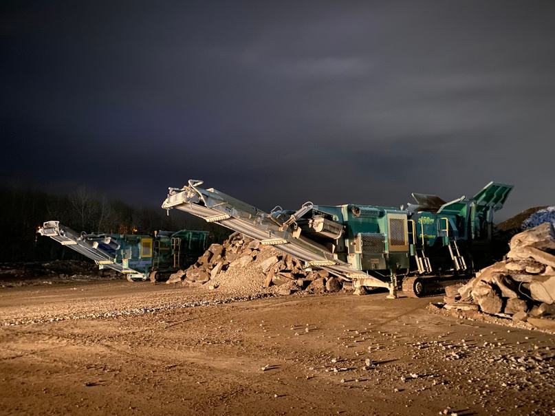 Crushing and screening plant working on a cleared demolition site